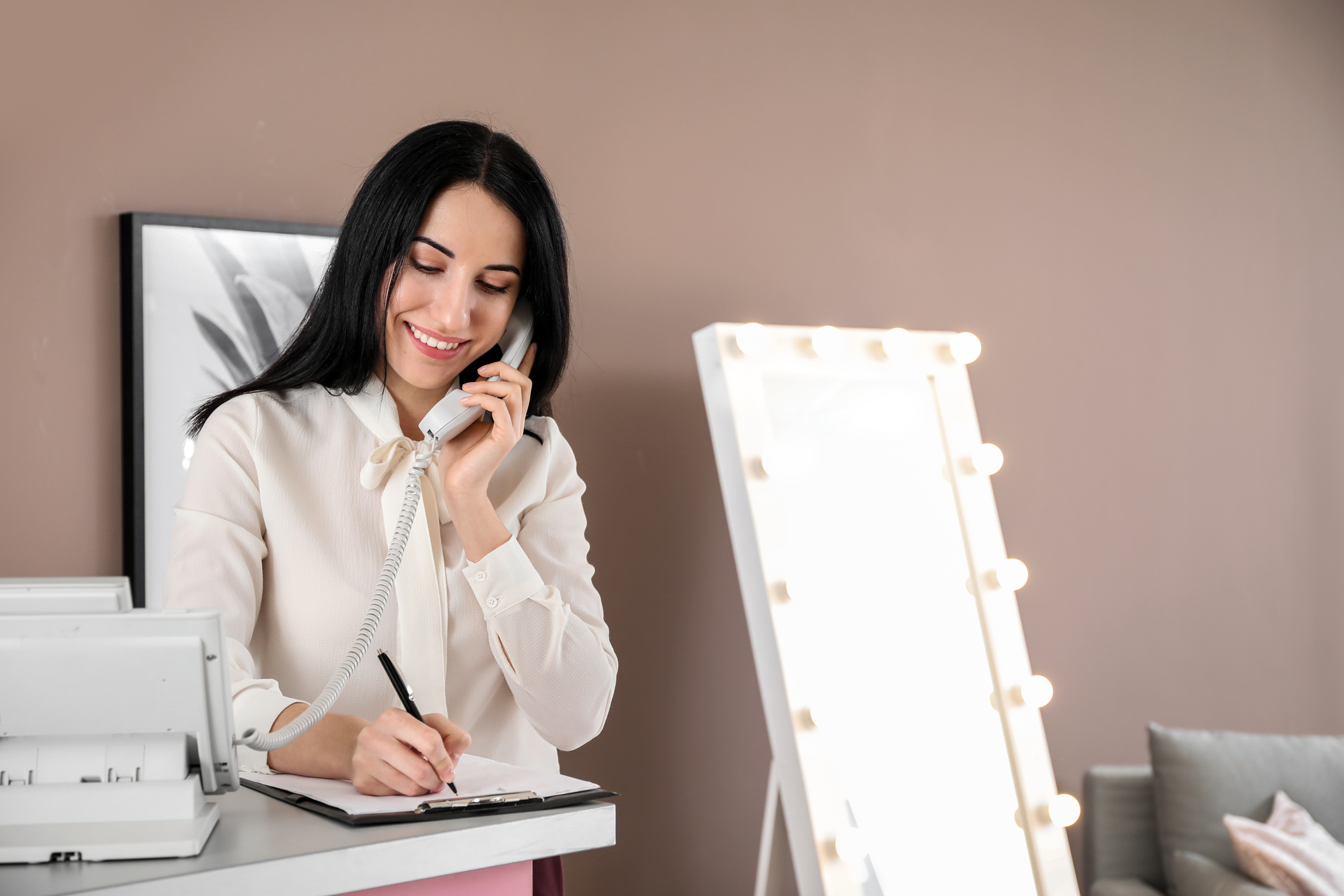 Young Female Receptionist Talking by Telephone in Hotel