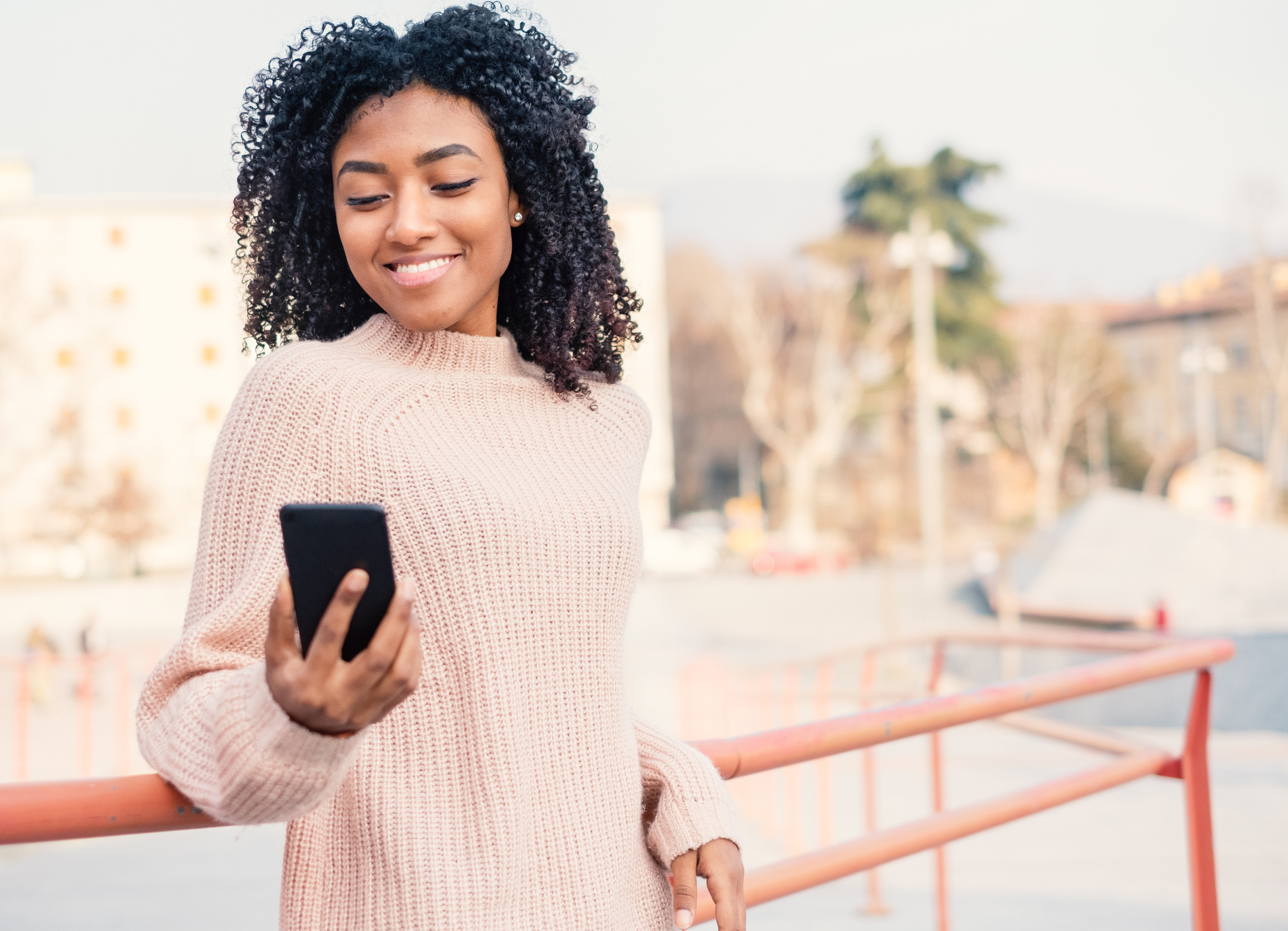 Black afro-american woman using mobile phone